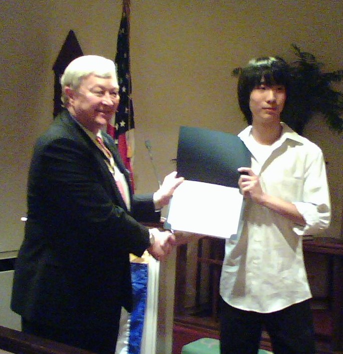 President Tom Speelman presents Mr. Ho with a certificate and a check for his winning essay.