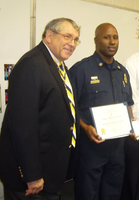 Captain II William Garrett (right) receives the Fire Safety Commendation Medal and certificate from Fairfax Resolves President Jack Sweeney