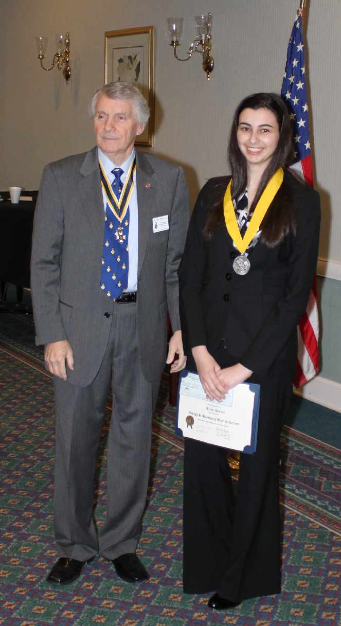 State Oration Chairman William Broadus presents Kristi Bowers with her award and $1000 check. Kristi was also awarded a medal in celebration of the Winter Olympics.