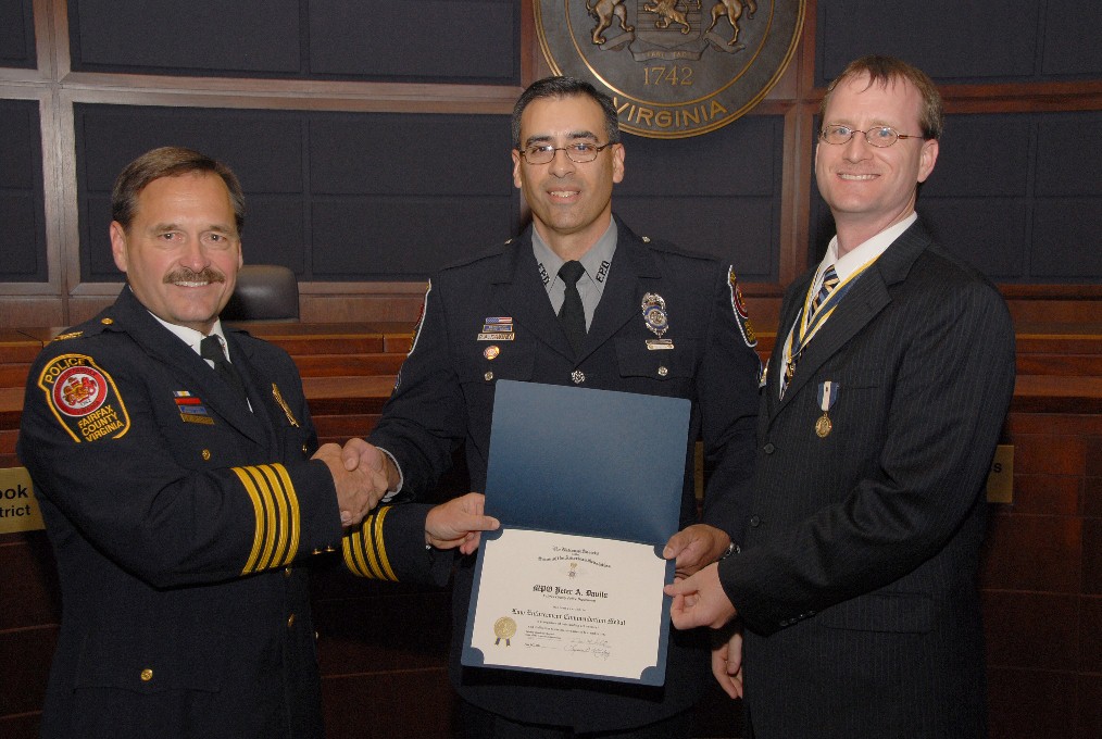 MPO Pete Davila receives the Law Enforcement Commendation Medal from Fairfax County Police Chief Col. David M. Rohrer (left) and President Darrin Schmidt.