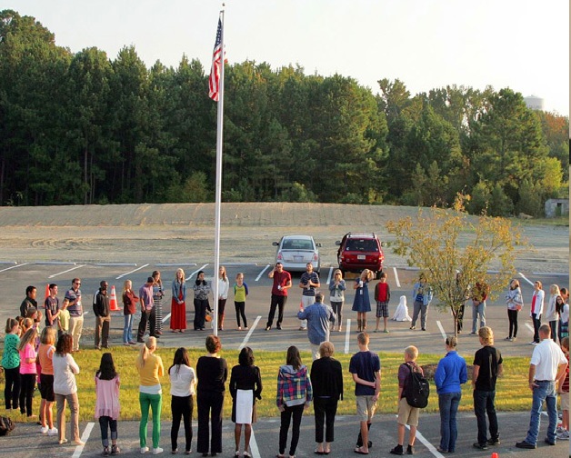 Grace Academy students attend a ceremony at the school's flag pole