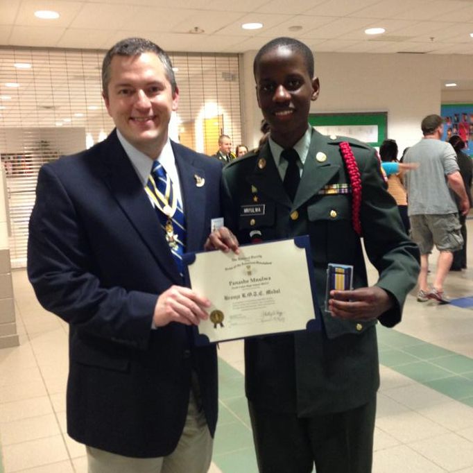Compatriot Dan Rolph presents the SAR JROTC Medal to Cadet Panashe Mnulwa at South Lakes High School on 21 May, 2013.