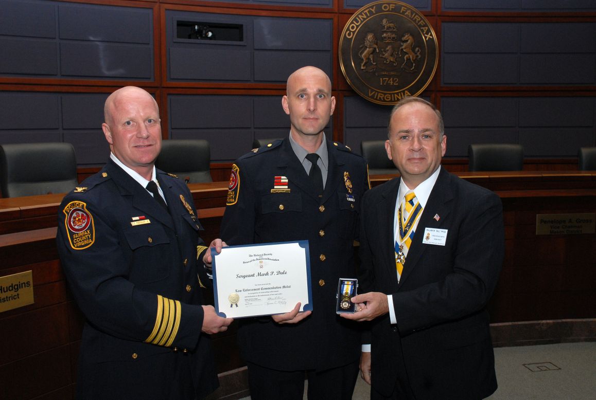 President Bill Price presents the Law Enforcement Commendation Medal to Sergeant Mark P. Dale.